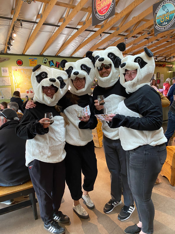 4 pandas celebrating.