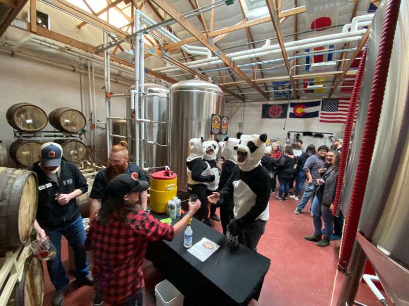 People enjoying beer in the brewery.