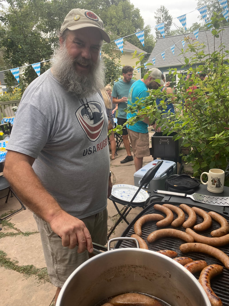 Tim grilling sausages outside