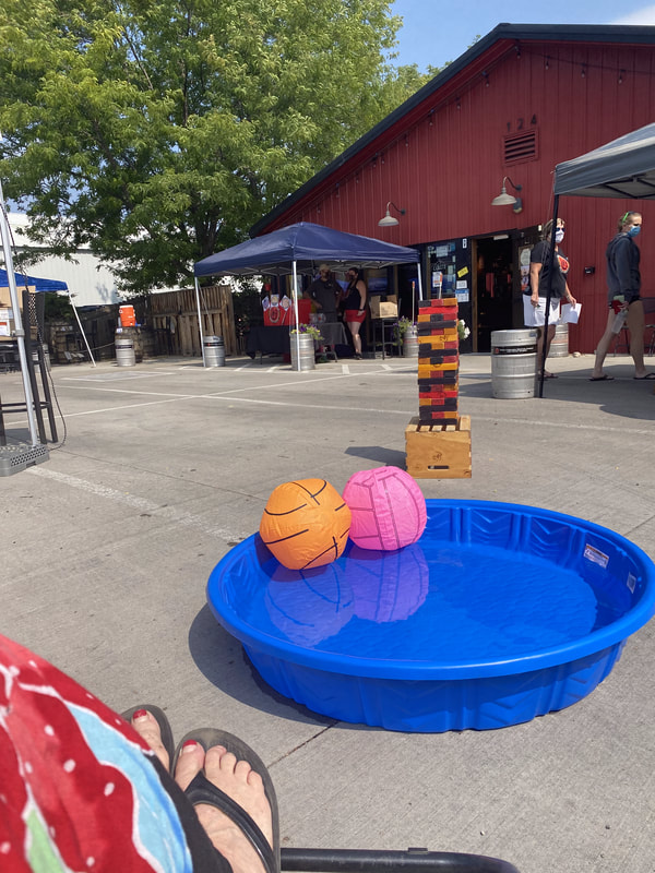 2 floating beach balls in a baby pool. 